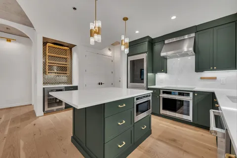 a view of kitchen with granite countertop window and front door
