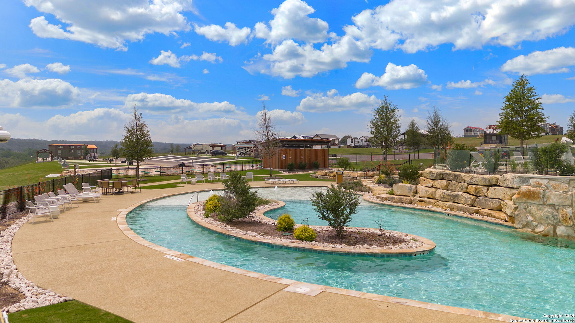 5386 Ranch Road 1376, Unit 101 Fredericksburg, TX 78624 - Photo 23 of 27 a view of a swimming pool with lawn chairs
