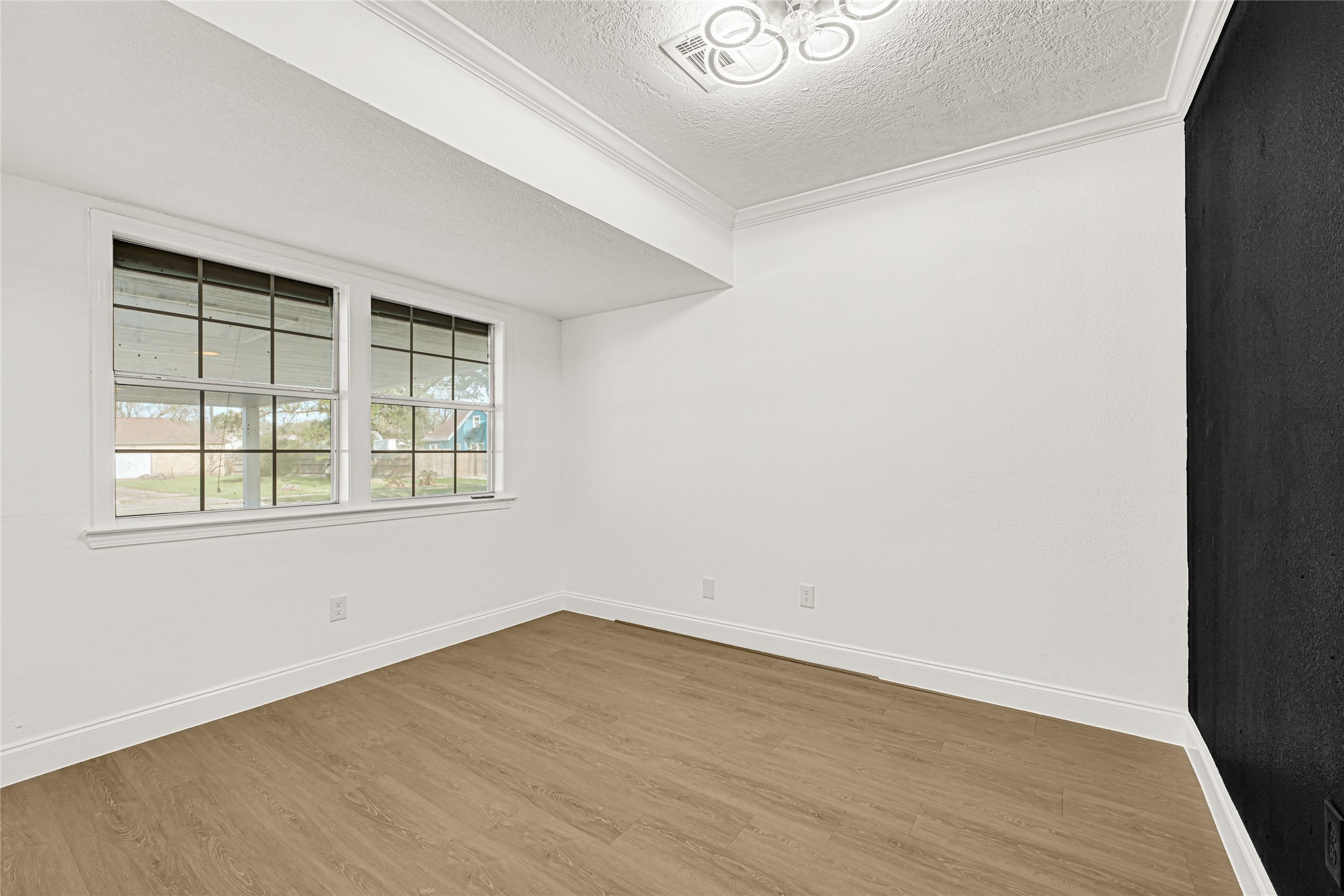 513 Main Street Pasadena, TX 77506 - Photo 16 of 35 an empty room with wooden floor and windows