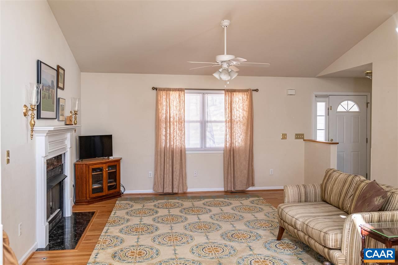 29 East Point Road Palmyra, VA 22963 - Photo 11 of 33 a living room with furniture a fireplace and a flat screen tv