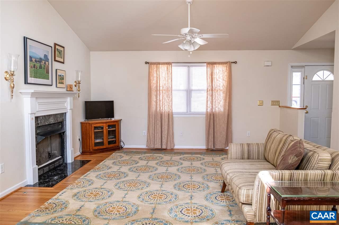 29 East Point Road Palmyra, VA 22963 - Photo 8 of 33 a living room with furniture a fireplace and a flat screen tv
