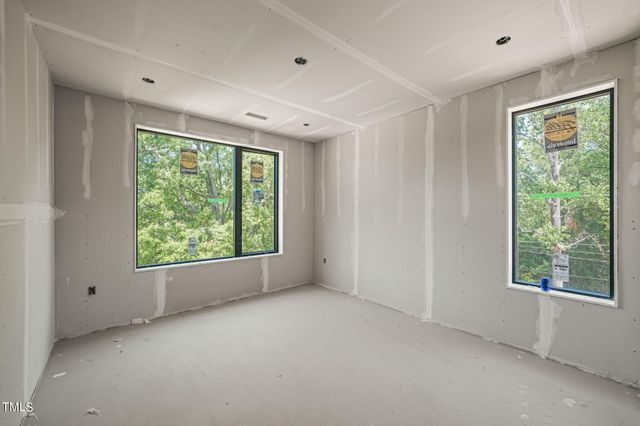 a view of a room with wooden floor and windows