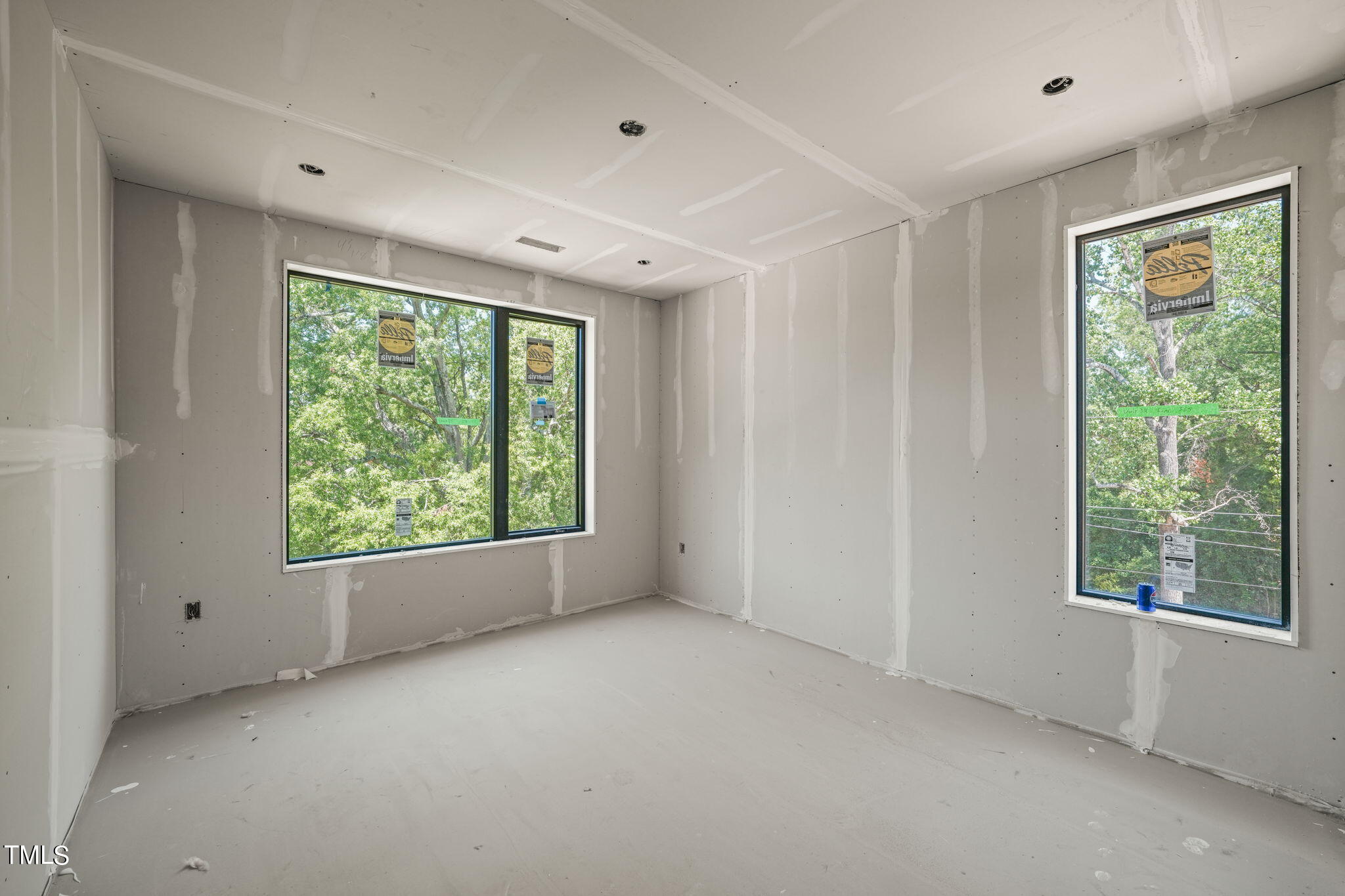29 Enterprise Street, Unit 311 Raleigh, NC 27607 - Photo 11 of 33 a view of a big room with windows and chandelier fan