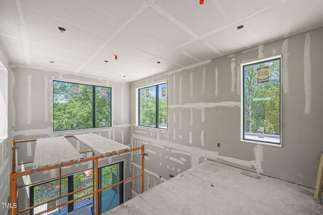 a view of a bedroom with furniture and windows