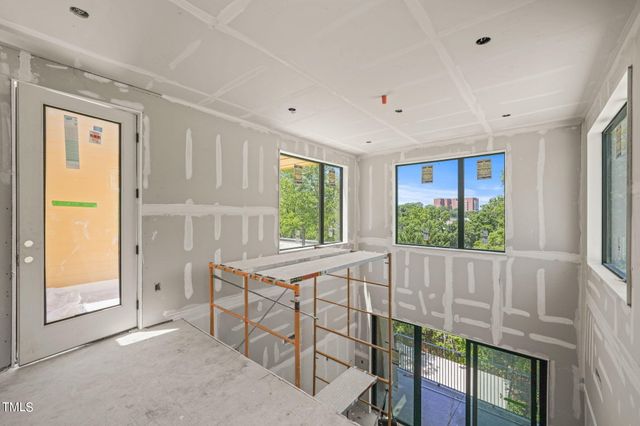 an empty room with windows and closet