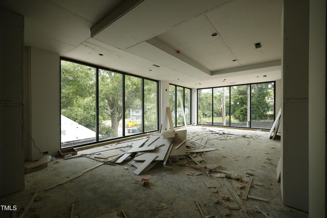a bed room with a bed and large windows