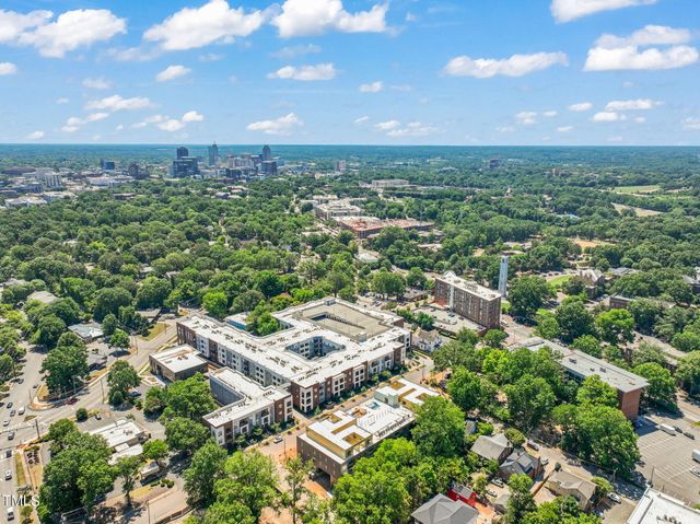 an aerial view of residential houses with city view