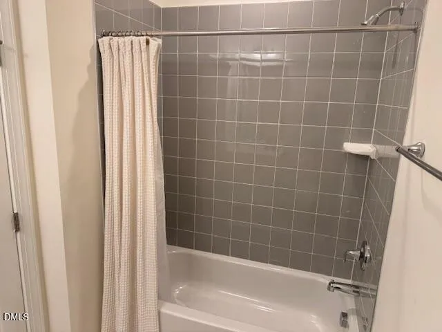 a open kitchen with kitchen island a refrigerator stove a sink and a dining table with wooden floor