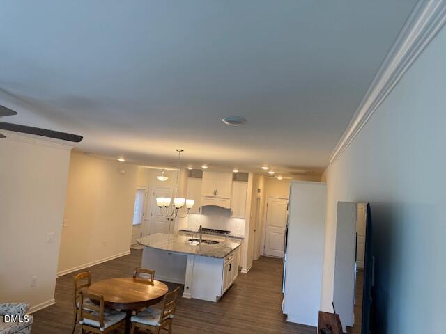 1010 Morrison Drive Durham, NC 27703 - Photo 24 of 29 a open kitchen with kitchen island a refrigerator stove a sink and a dining table with wooden floor