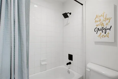 a bathroom with double vanity sinks and a mirror