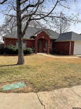 a large tree in front of a house