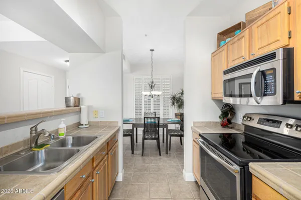 a kitchen with stainless steel appliances a refrigerator and a stove top oven
