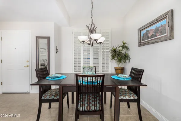 a view of a dining room with a table and chairs