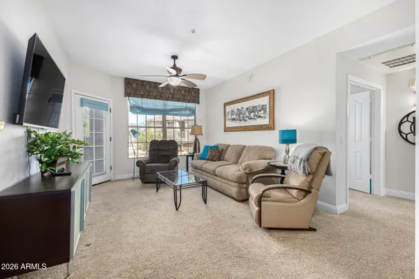 a living room with furniture and a flat screen tv