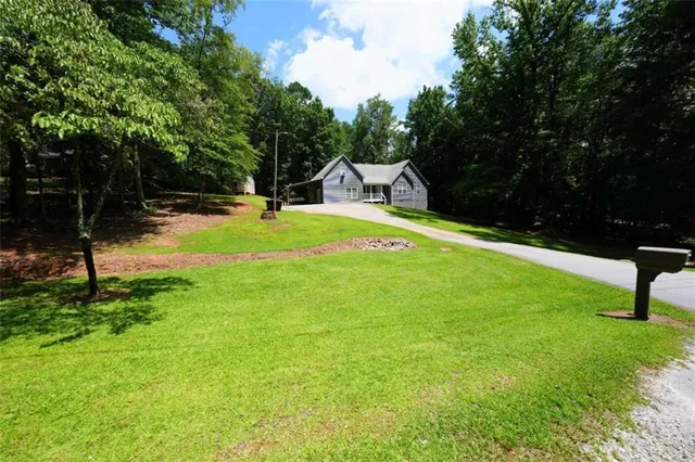 a swimming pool with lots of tress in front of it