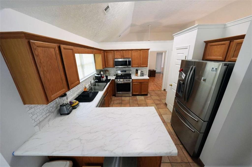 7908 Lambert Road Winston, GA 30187 - Photo 9 of 30 a view of a kitchen with fridge and wooden floor
