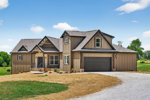 a front view of a house with yard and porch