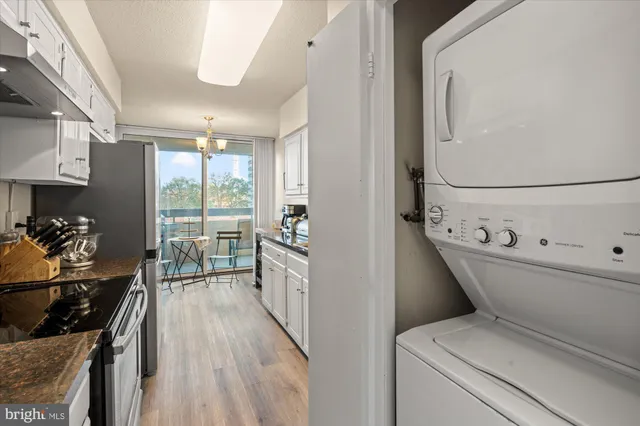 a view of a hallway with washer and dryer