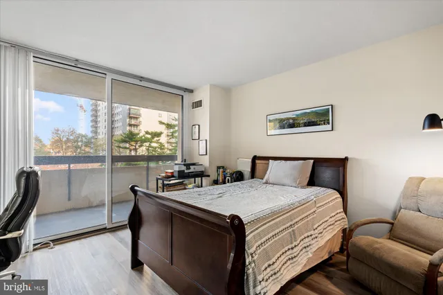 a bedroom with a bed and a large window