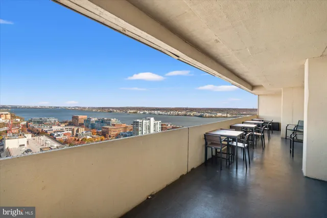 a view of roof deck with dining table and chairs