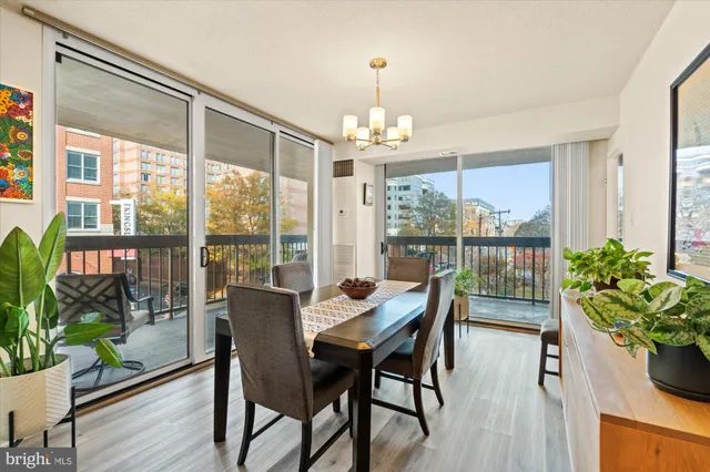 a dining room with furniture wooden floor and a chandelier