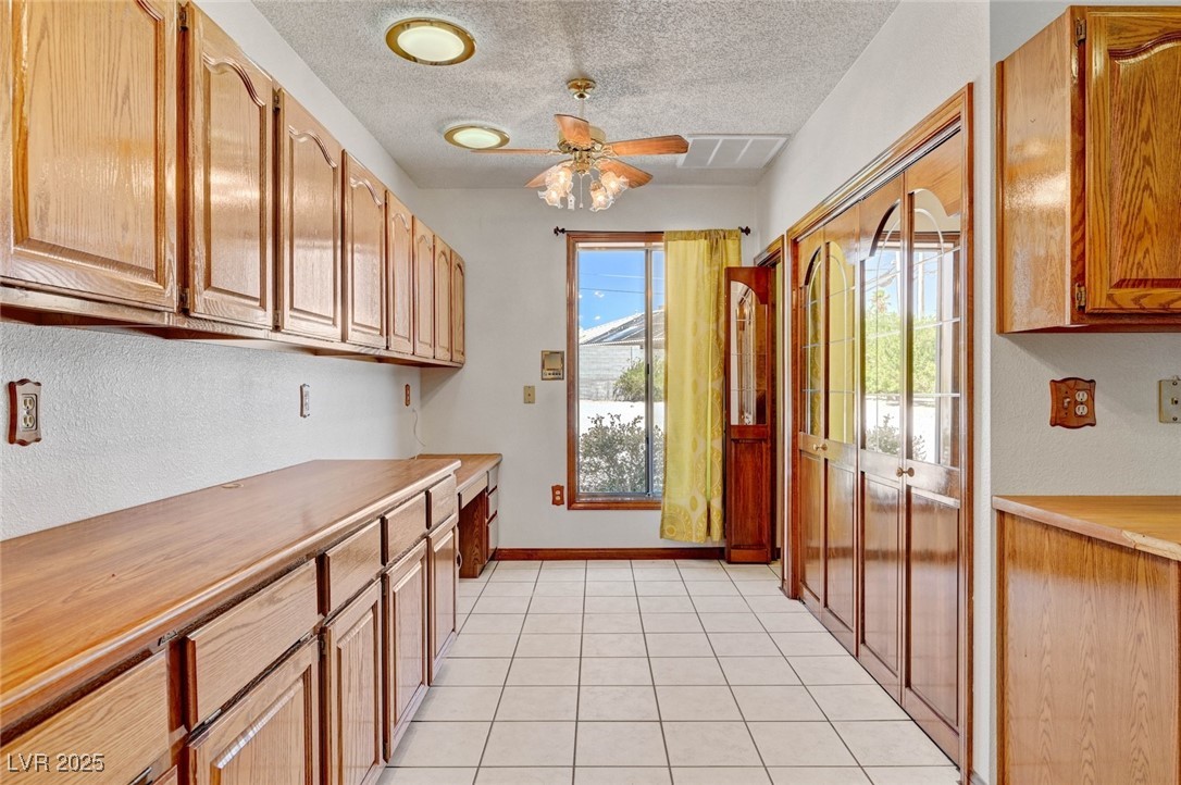 8970 West Lone Mountain Road Las Vegas, NV 89149 - Photo 36 of 94 Laundry and built in office area between the family room and downstairs bed and bath off the garage
