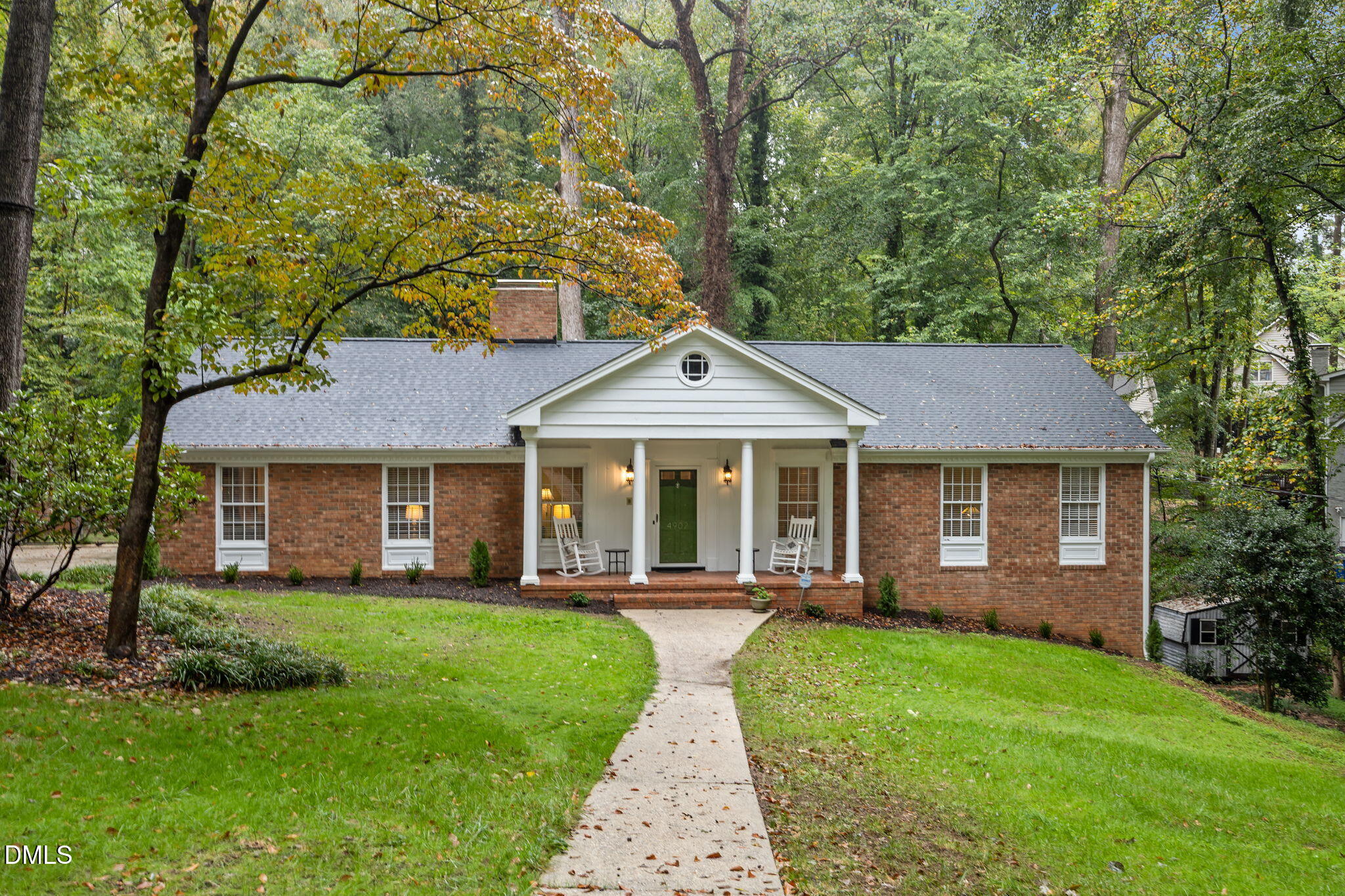 a front view of a house with a yard and porch