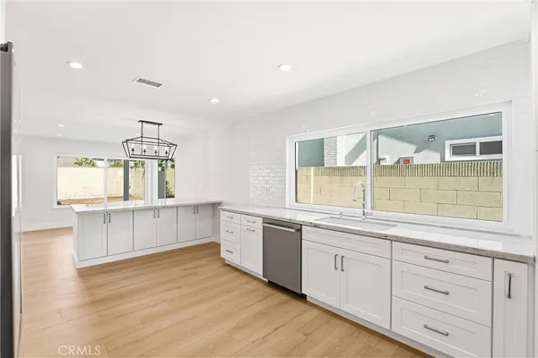 a kitchen with stainless steel appliances granite countertop a refrigerator stove and sink