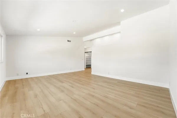 a bathroom with a granite countertop sink a toilet and a mirror