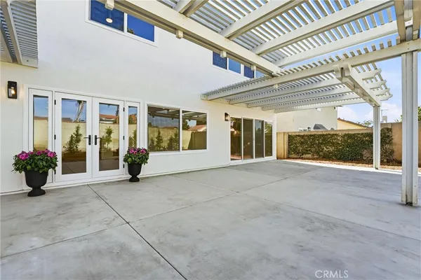 a front view of a house with a garden and trees