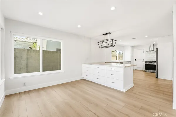 a view of a kitchen with furniture and wooden floor