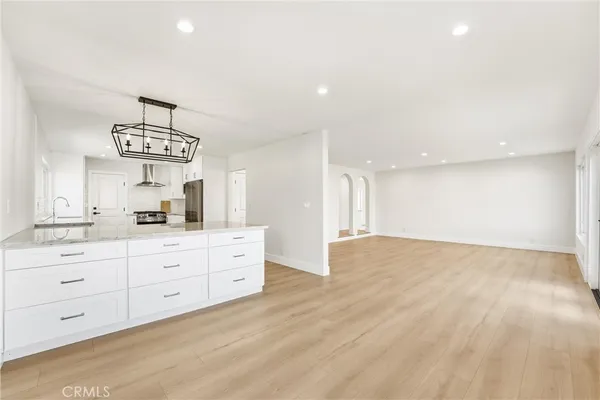 a kitchen with stainless steel appliances granite countertop a stove a sink and a refrigerator