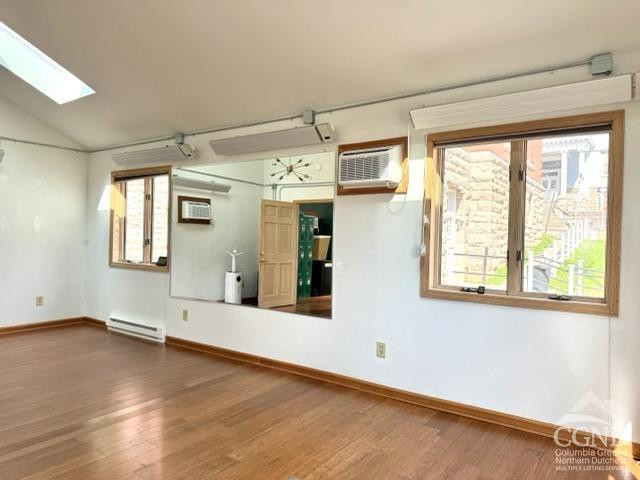 75 Bridge Street Catskill, NY 12414 - Photo 9 of 17 an empty room with wooden floor and windows