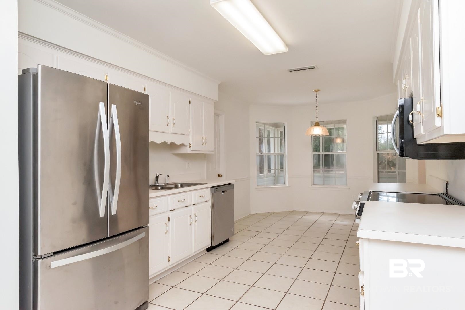 10006 Wedgefield Court Mobile, AL 36608 - Photo 22 of 34 Kitchen featuring hanging light fixtures, white cabinetry, appliances with stainless steel finishes, and light countertops