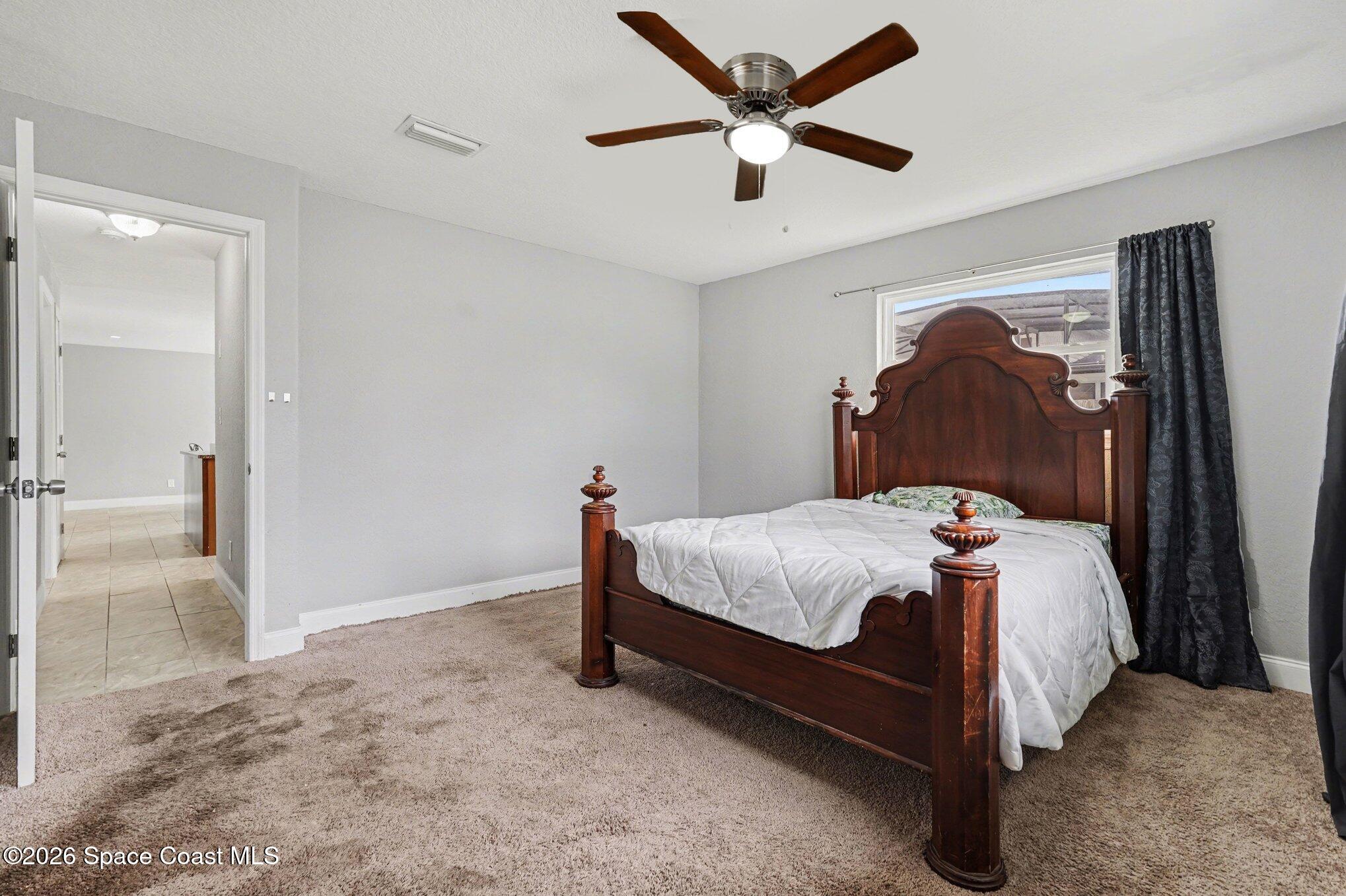 455 Riverside Avenue Merritt Island, FL 32953 - Photo 12 of 28 a bedroom with a bed and a painting on the wall