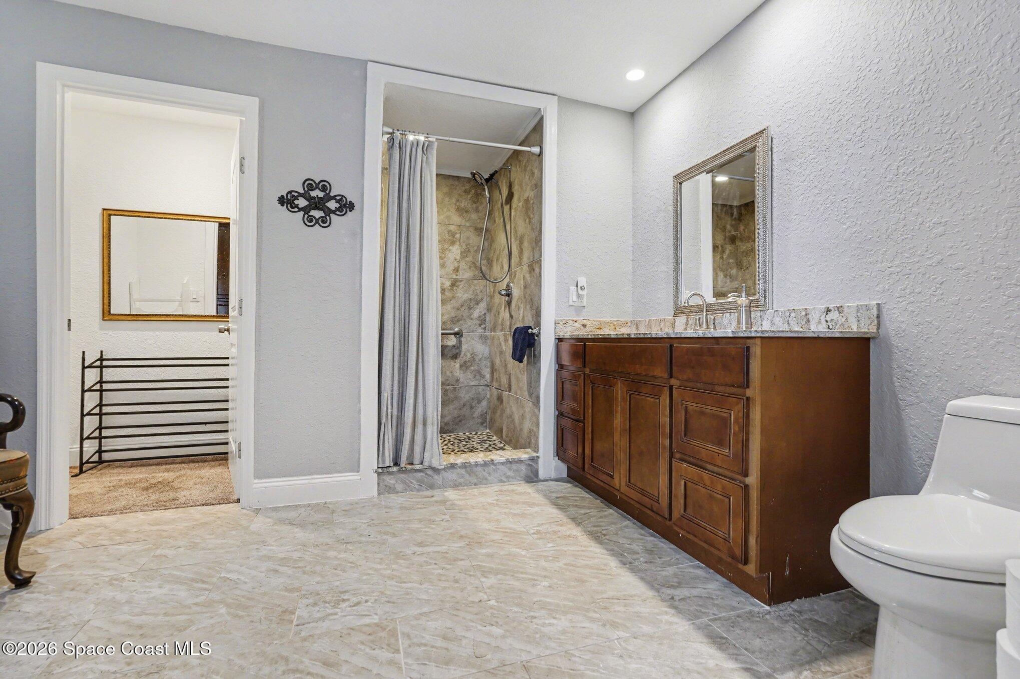 455 Riverside Avenue Merritt Island, FL 32953 - Photo 13 of 28 a bathroom with a sink a toilet and shower