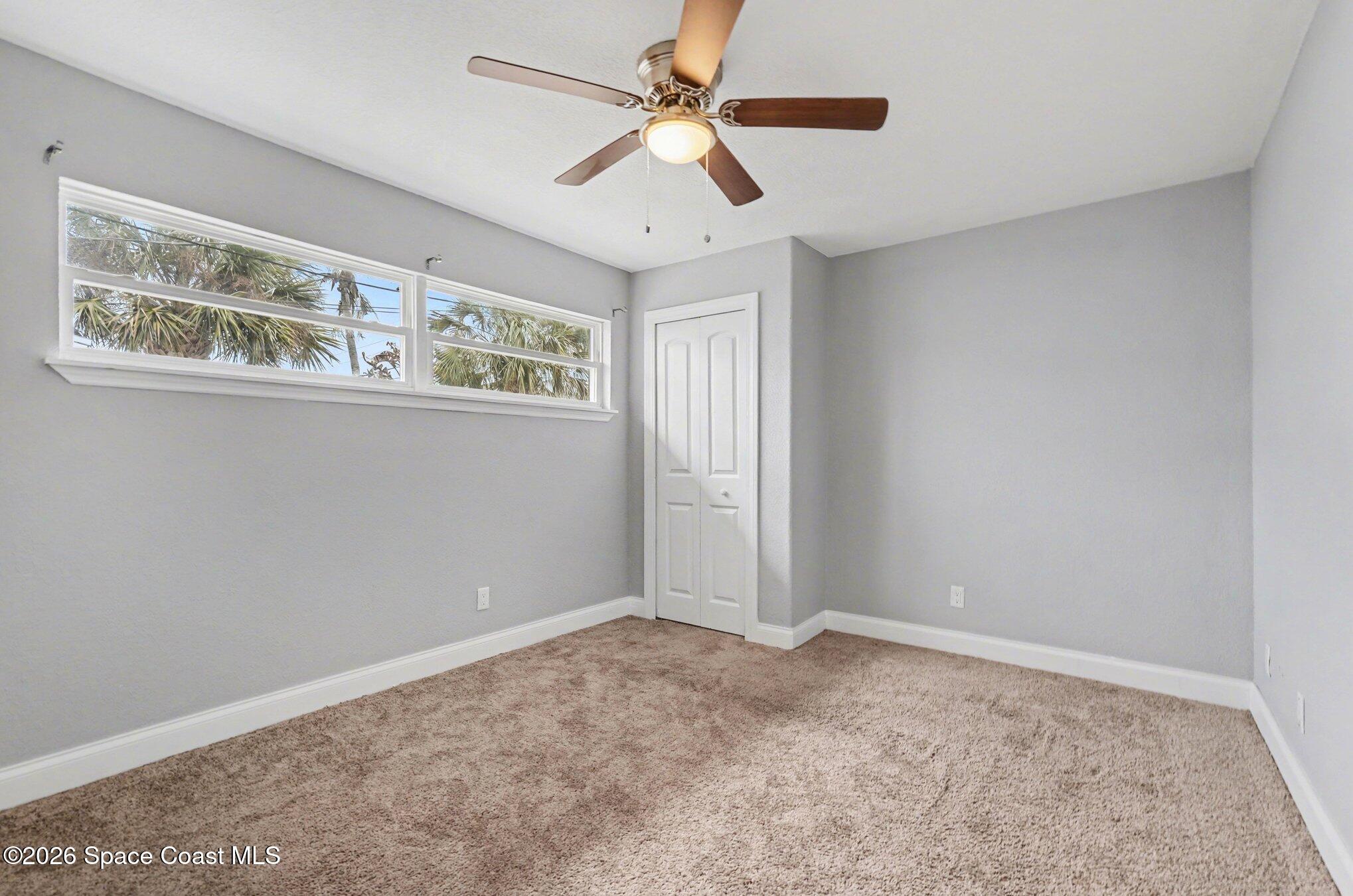 455 Riverside Avenue Merritt Island, FL 32953 - Photo 15 of 28 a view of an empty room with window and ceiling fan