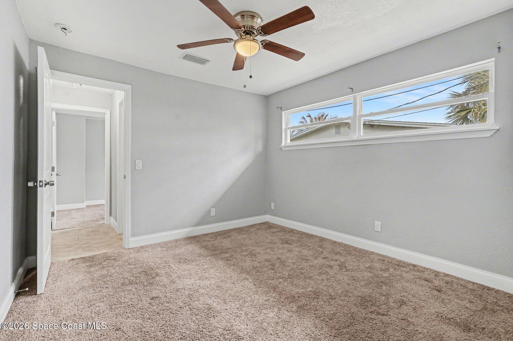 455 Riverside Avenue Merritt Island, FL 32953 - Photo 16 of 28 an empty room with windows and fan