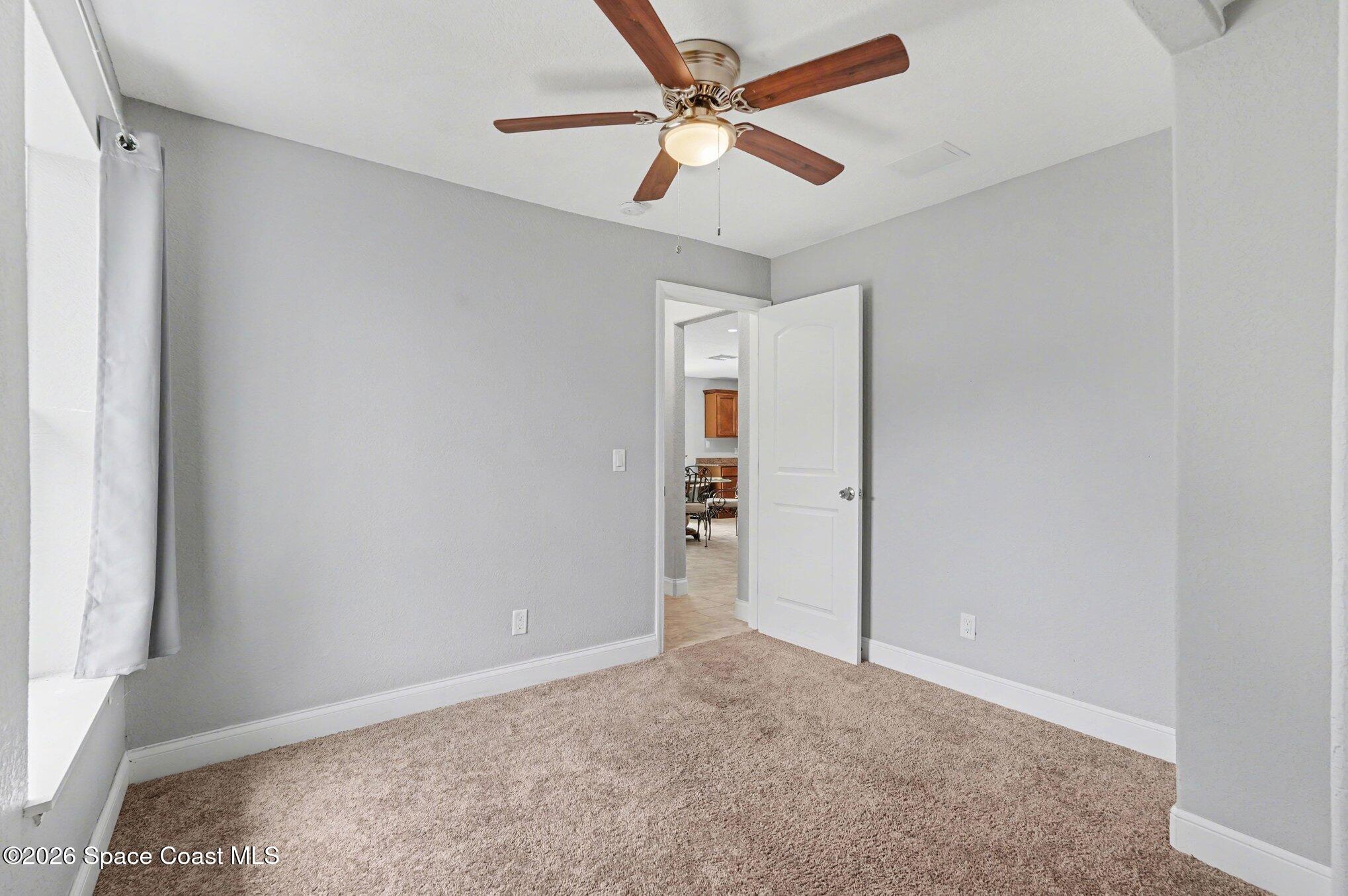 455 Riverside Avenue Merritt Island, FL 32953 - Photo 18 of 28 an empty room with closet and a ceiling fan