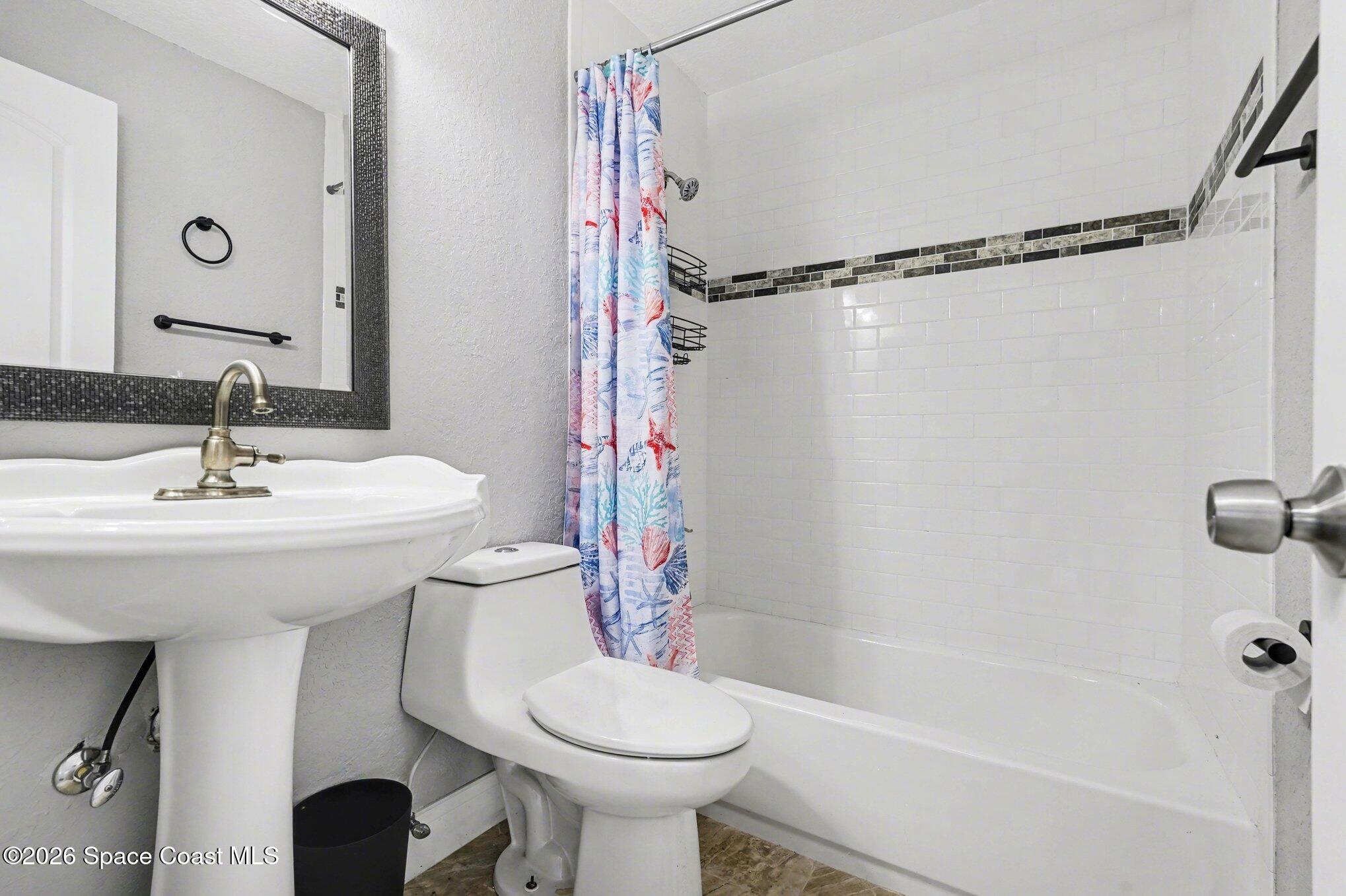 455 Riverside Avenue Merritt Island, FL 32953 - Photo 21 of 28 a bathroom with a sink toilet and shower