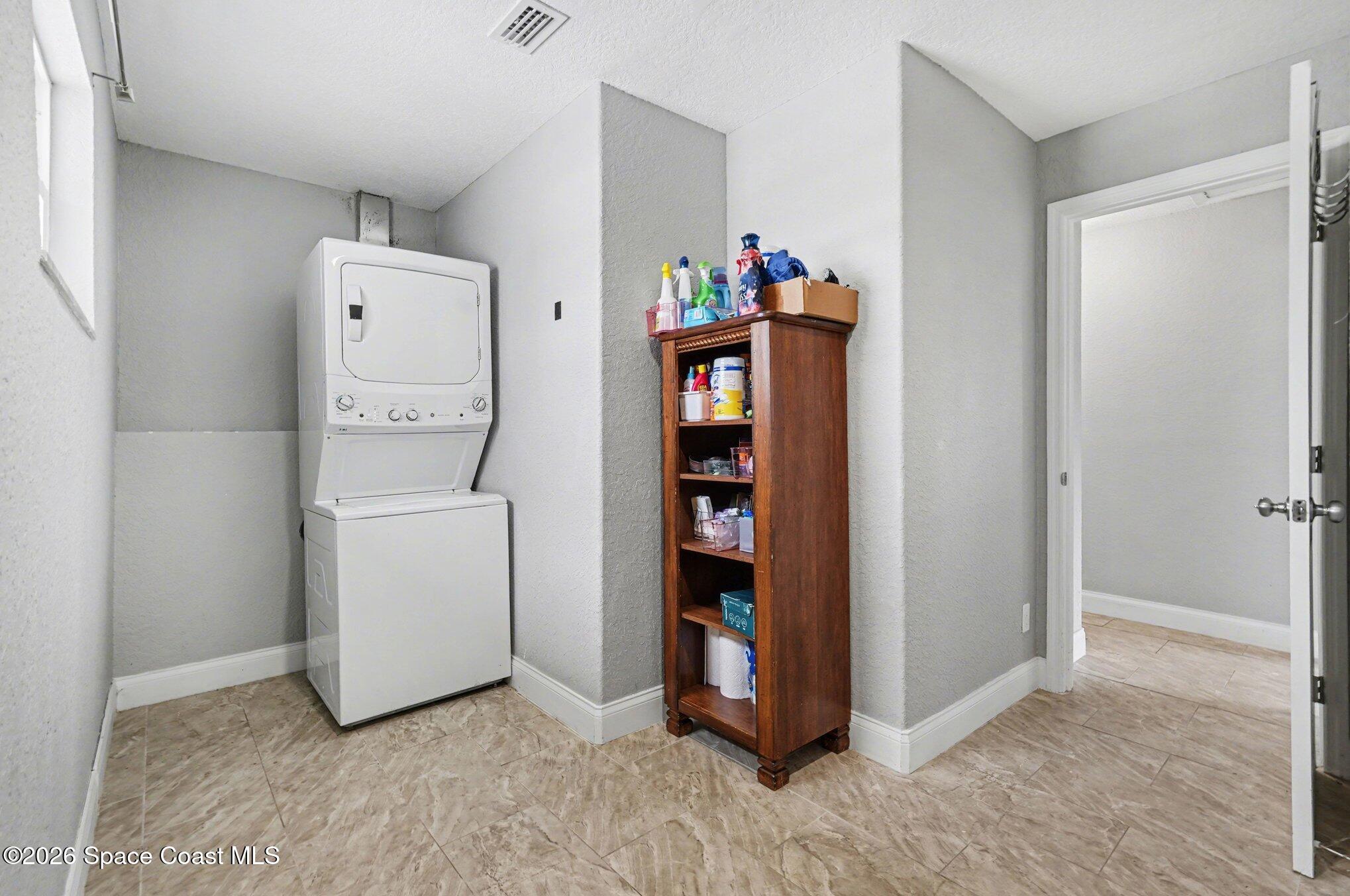 455 Riverside Avenue Merritt Island, FL 32953 - Photo 22 of 28 a view of storage and utility room with washer and dryer
