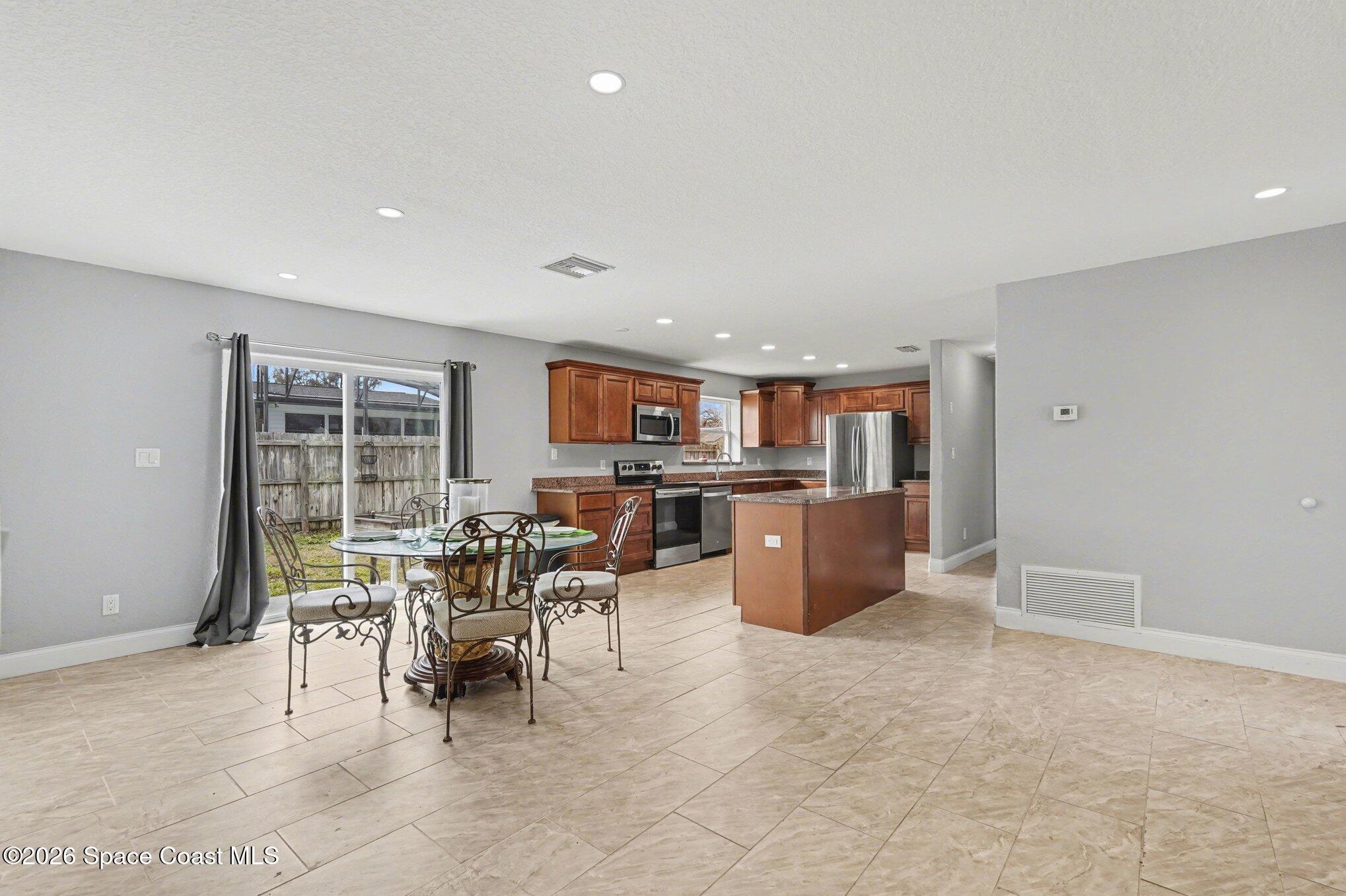 455 Riverside Avenue Merritt Island, FL 32953 - Photo 28 of 28 a view of a dining room with furniture and a kitchen