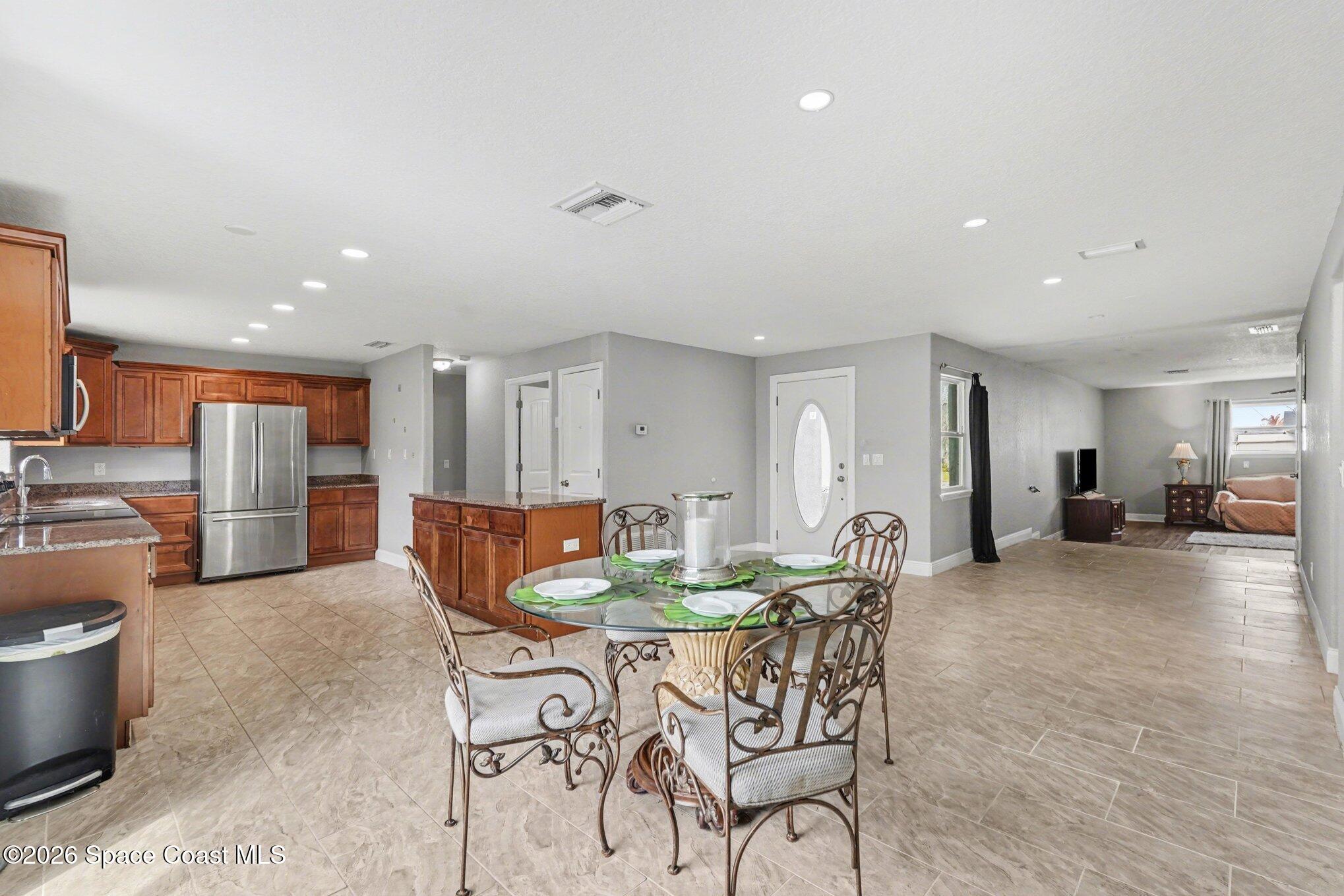 455 Riverside Avenue Merritt Island, FL 32953 - Photo 6 of 28 a dining room with furniture and a wooden floor