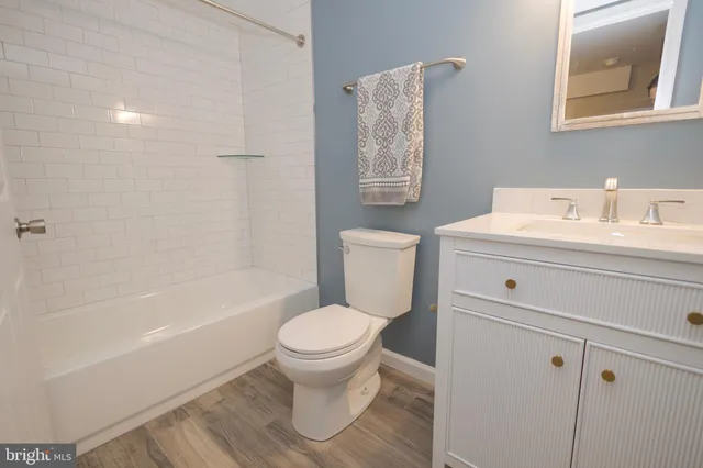 a white toilet sitting next to a bathroom sink