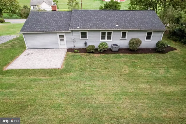 a aerial view of a house with table and chairs