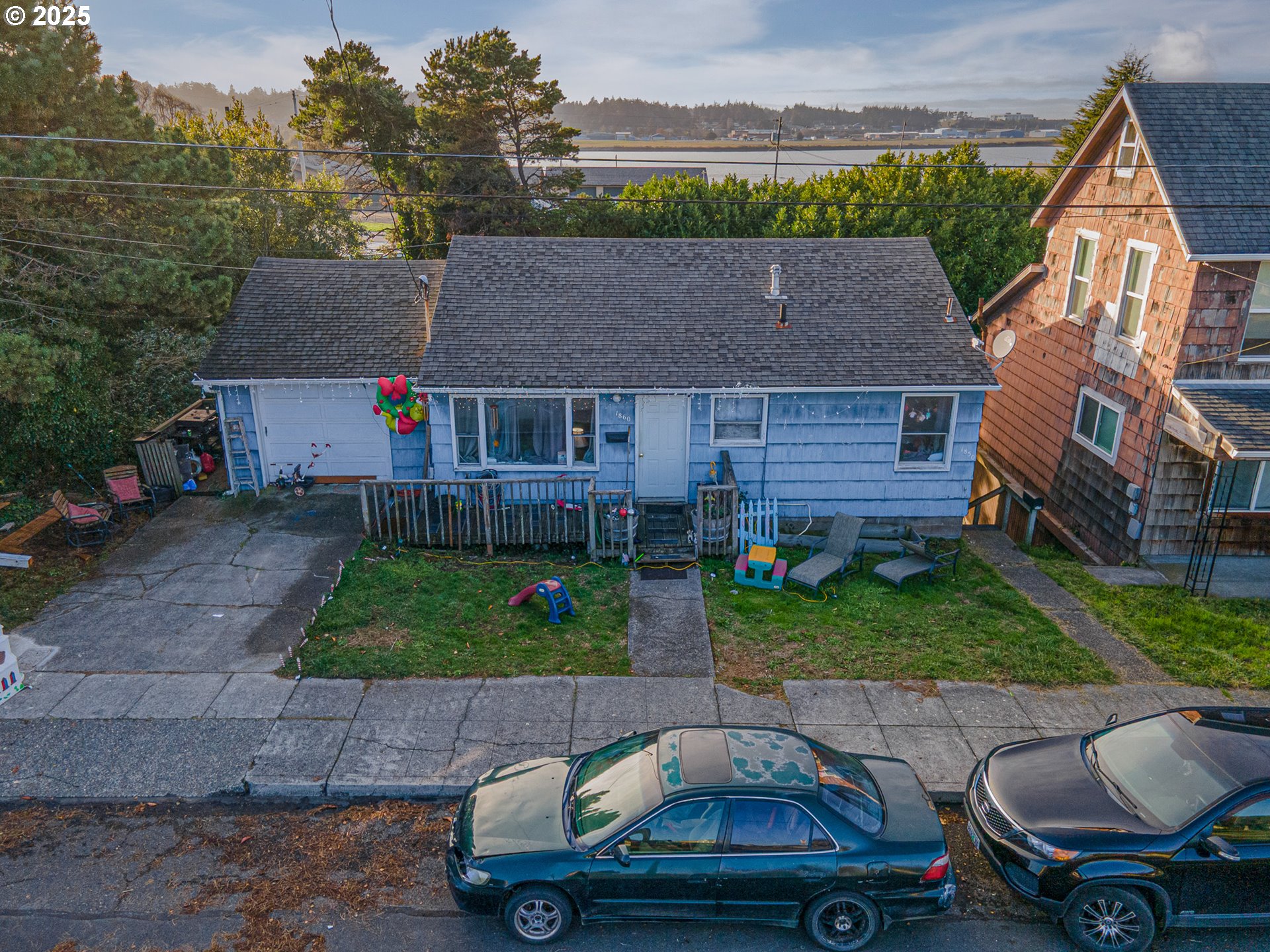 1860 Meade Avenue North Bend, OR 97459 - Photo 1 of 38 an aerial view of a house with a yard garden and outdoor seating