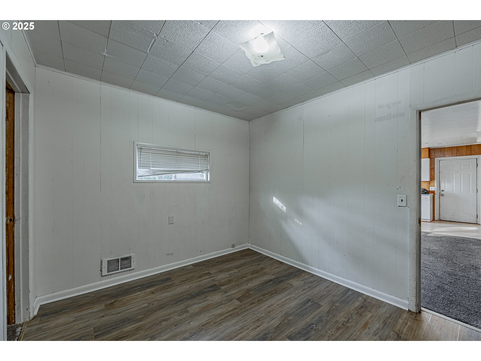 1860 Meade Avenue North Bend, OR 97459 - Photo 26 of 38 a view of an empty room with wooden floor