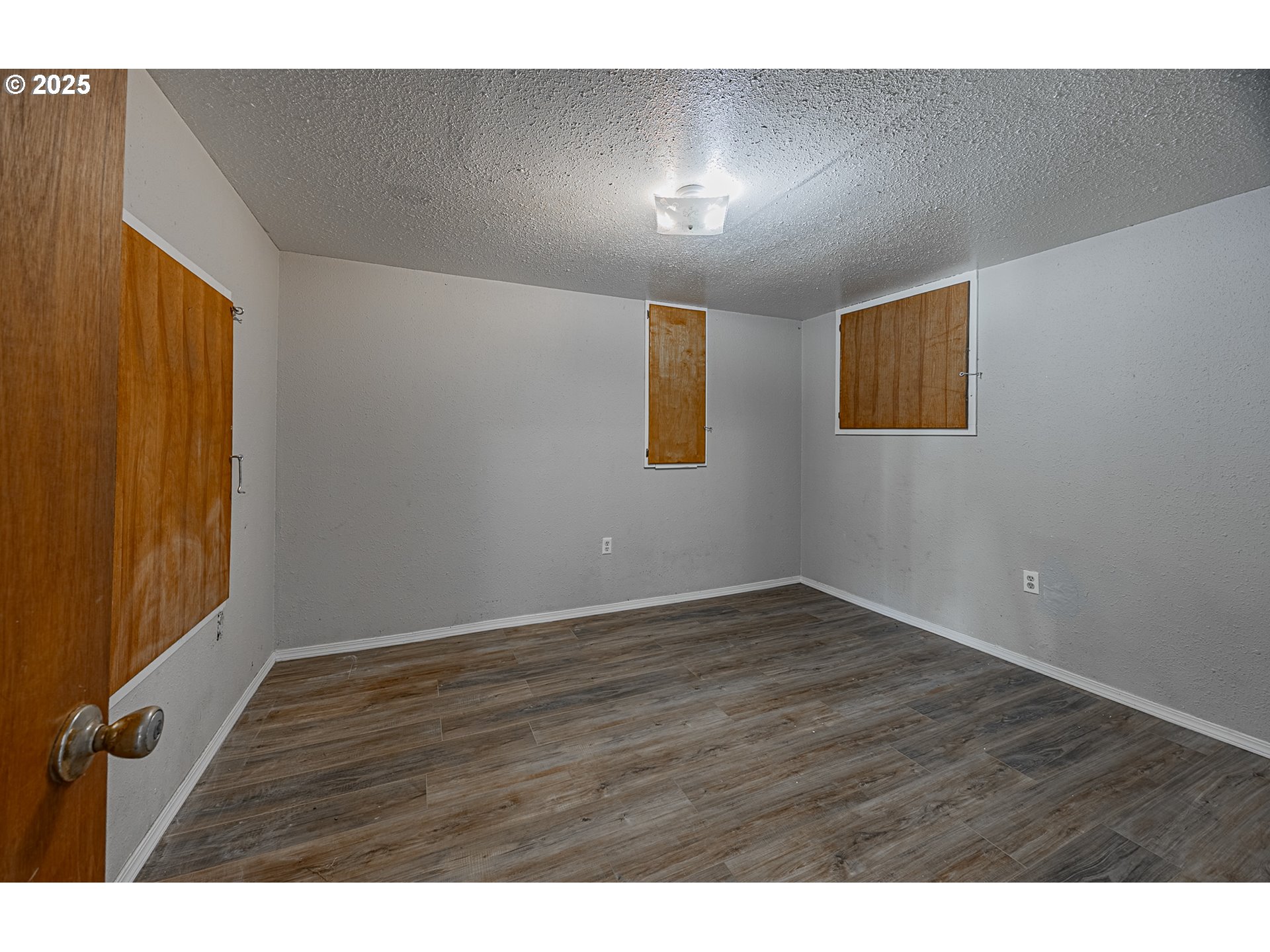 1860 Meade Avenue North Bend, OR 97459 - Photo 27 of 38 a view of an empty room with wooden floor