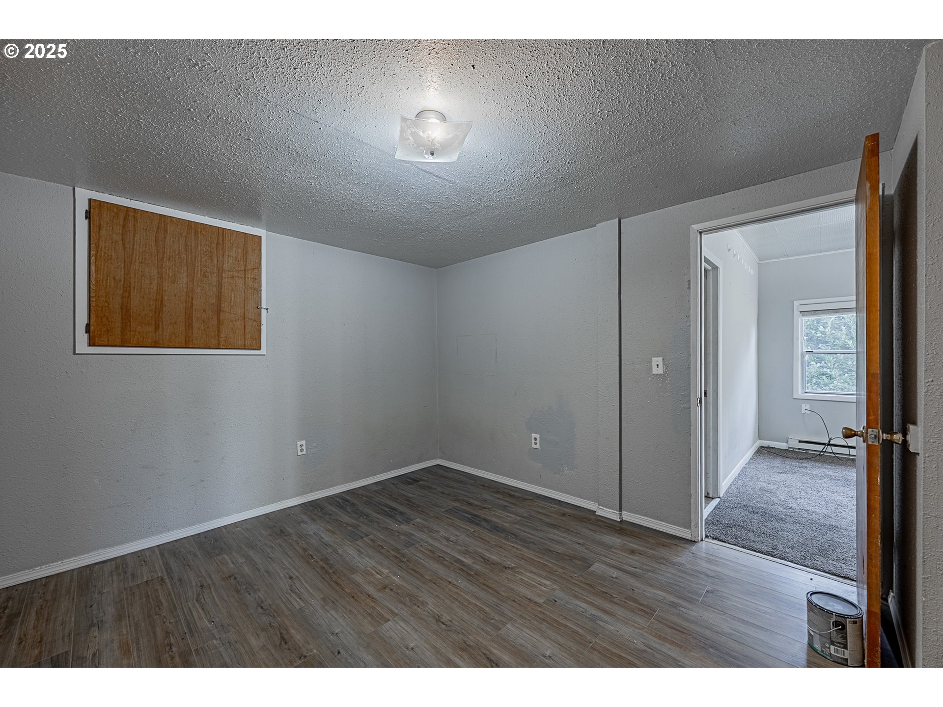 1860 Meade Avenue North Bend, OR 97459 - Photo 29 of 38 a view of an empty room with wooden floor and a window