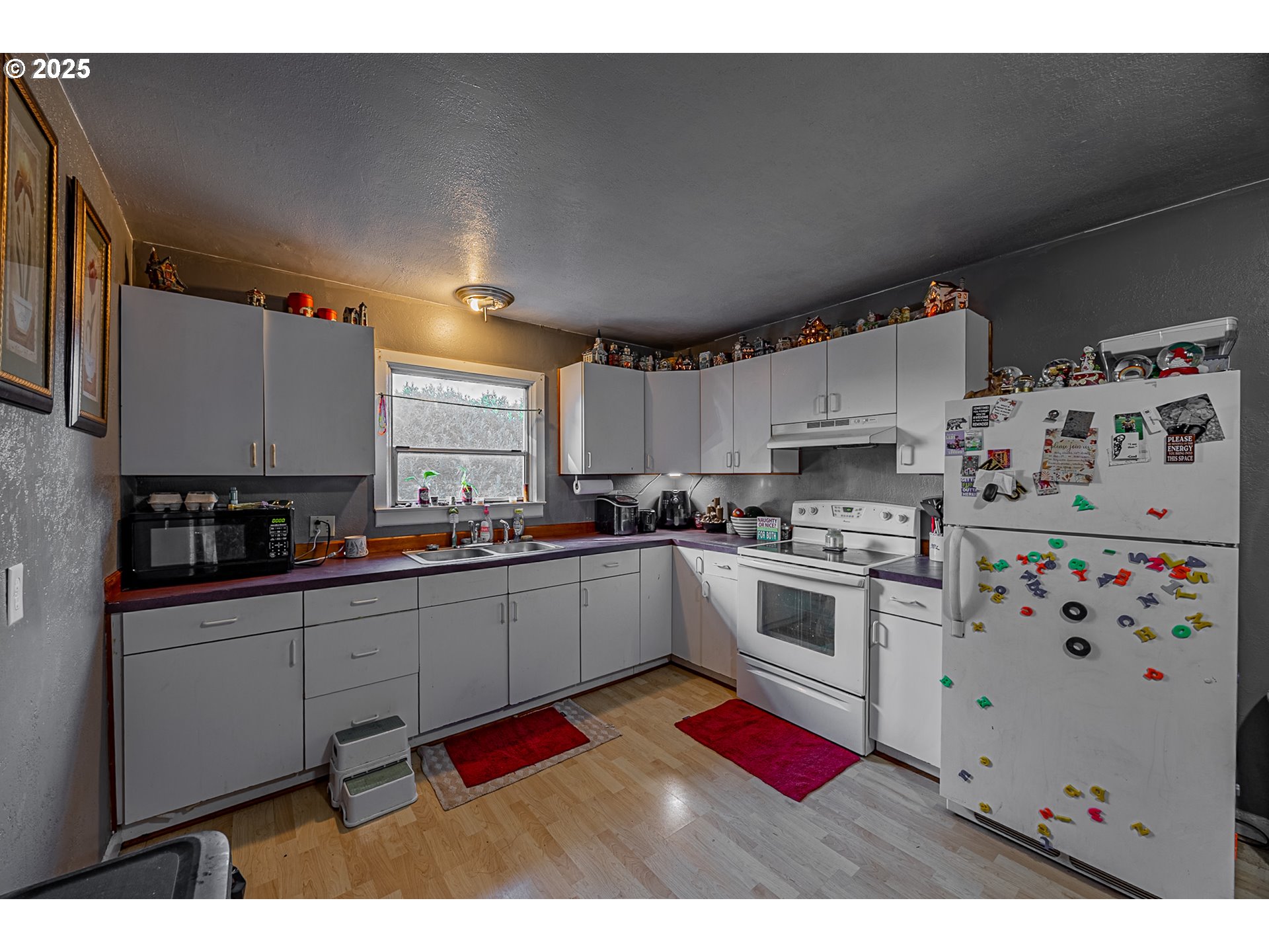 1860 Meade Avenue North Bend, OR 97459 - Photo 6 of 38 a kitchen with stainless steel appliances a stove a sink a refrigerator and cabinets